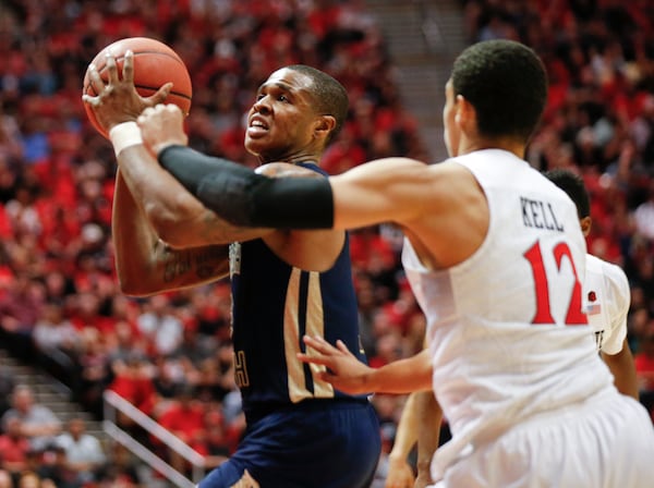 Georgia Tech guard Marcus Georges-Hunt is fouled by San Diego State guard Trey Kell while driving to the basket during the second half in an NCAA college basketball game in the men's NIT, Wednesday, March 23, 2016, in San Diego. (AP Photo/Lenny Ignelzi)