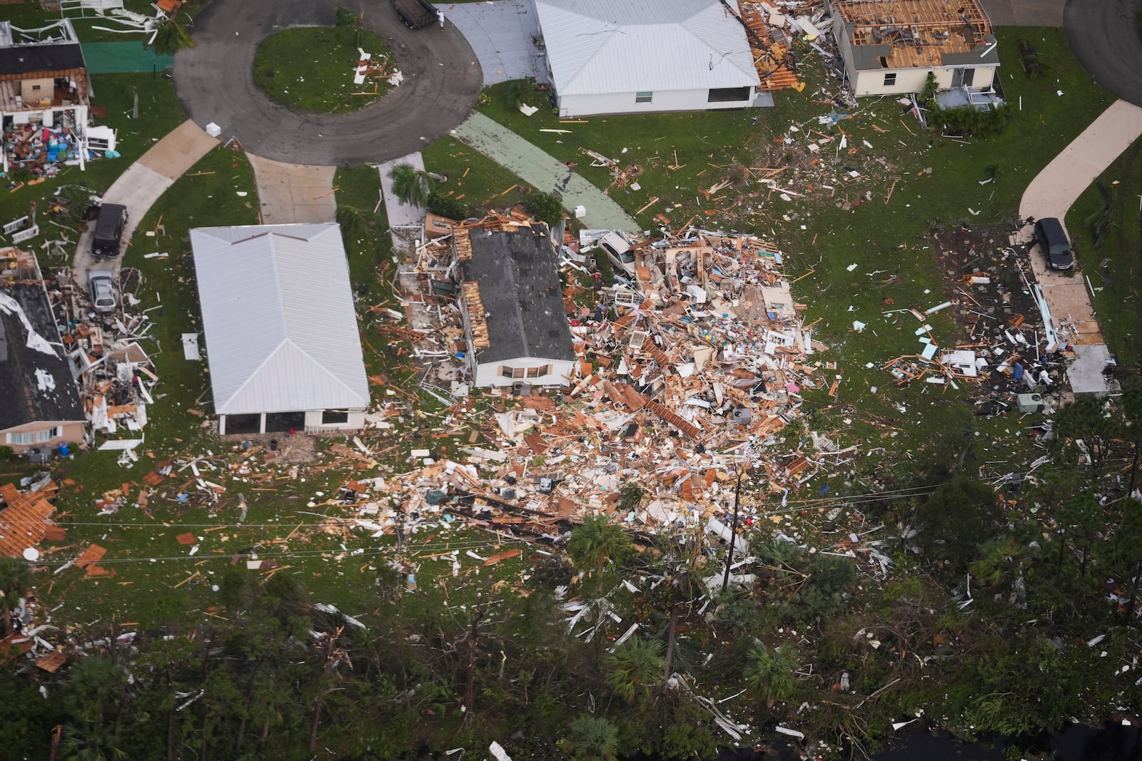 Neighborhoods destroyed by tornadoes are seen in this aerial photo in the aftermath of Hurricane Milton, Thursday, Oct. 10, 2024, in Fort Pierce, Fla. (AP Photo/Gerald Herbert)