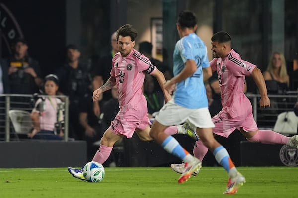 Inter Miami forward Lionel Messi (10) carries the ball as New York City FC forward Agustin Ojeda (26) looks to defend during the first half of an MLS soccer match, Saturday, Feb. 22, 2025, in Fort Lauderdale, Fla. (AP Photo/Rebecca Blackwell)