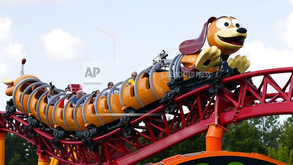 In this Saturday, June 23, 2018 photo, guests ride the Slinky Dog Dash coaster at Toy Story Land in Disney's Hollywood Studios at Walt Disney World in Lake Buena Vista, Fla. (AP Photo/John Raoux)