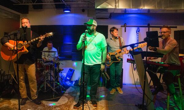 The members of The Grits (from the left) -- Terry Cannon, Allan Vella, Bobby Carter, Bo Vaden and Jeremy Rhett -- rehearse for their role as an opening act in the 17th annual holiday variety show, "Mighty Mo & More." CHRISTINA MATACOTTA FOR THE ATLANTA JOURNAL-CONSTITUTION.