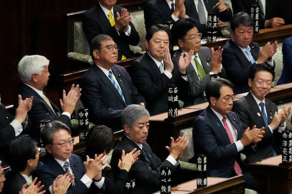 Lawmakers applaud as Japanese Prime Minister Shigeru Ishiba, second left on top, was elected for a new prime minister at a special parliamentary session of the lower house Monday, Nov. 11, 2024, in Tokyo. (AP Photo/Eugene Hoshiko)