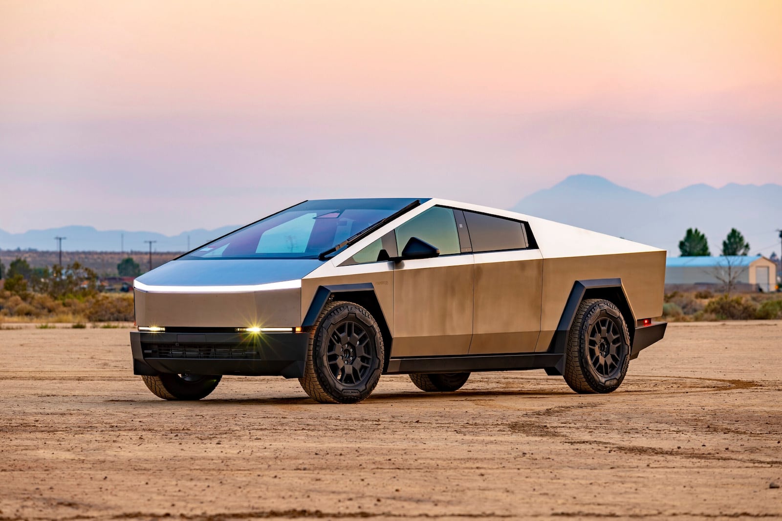 This photo provided by Edmunds shows the 2024 Tesla Cybertruck. The Cybertruck can drive more than 300 miles on a full charge and tow up to 11,000 pounds. (Courtesy of Edmunds via AP)