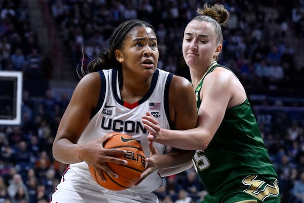 UConn forward Sarah Strong, left, is guarded by South Florida guard Carla Brito in the first half of an NCAA college basketball game, Sunday, Nov. 10, 2024, in Storrs, Conn. (AP Photo/Jessica Hill)