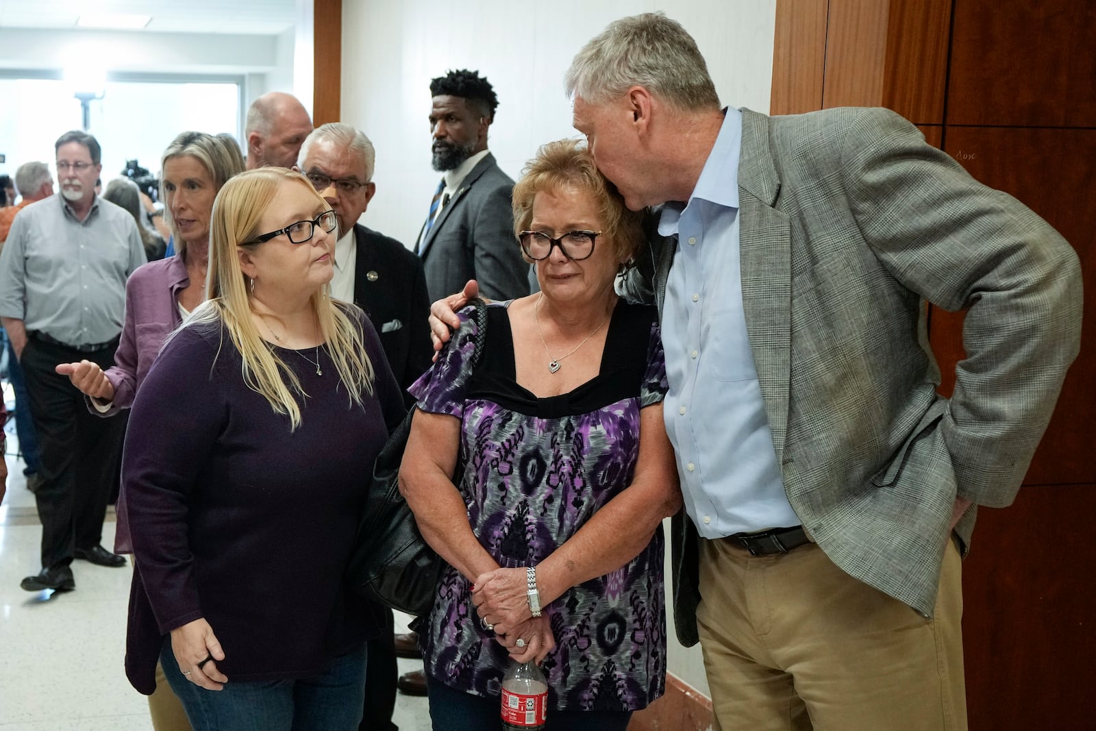 The family of Dennis Tuttle and Rhogena Nicholas gather outside the courtroom after former Houston police officer Gerald Goines was sentenced to 60 years behind bars on a pair of felony murder convictions on Tuesday, Oct. 8, 2024, in Houston. Goines was found guilty of felony murder in the 2019 deaths of Tuttle and Nicholas. (Brett Coomer/Houston Chronicle via AP)