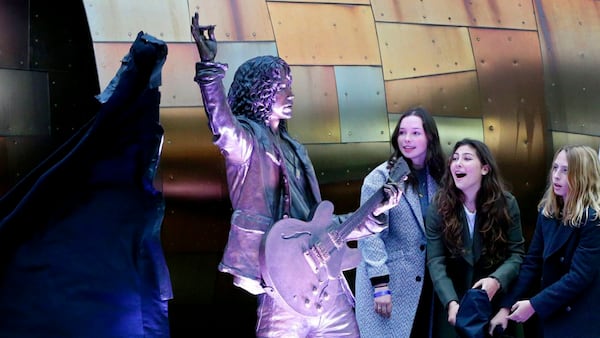 The children of Soundgarden frontman Chris Cornell, who died of suicide in May 2017, unveil his statue, Sunday, Oct. 7, 2018, outside MoPOP, in Seattle. From left: Lily, 18; Toni, 14; and Christopher, 12. (Ken Lambert/The Seattle Times via AP)