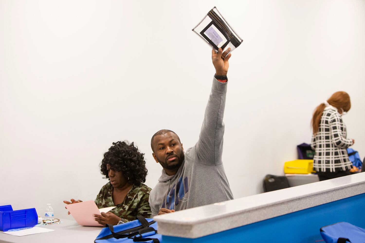 Workers at the Gwinnett County Voter Registrations and Elections headquarters count votes delivered by poll managers in the Senate runoff election on Tuesday, December 6, 2022, in Lawrenceville, Georgia. Candidates incumbent Raphael Warnock and Herschel Walker faced off for the seat.  CHRISTINA MATACOTTA FOR THE ATLANTA JOURNAL-CONSTITUTION.