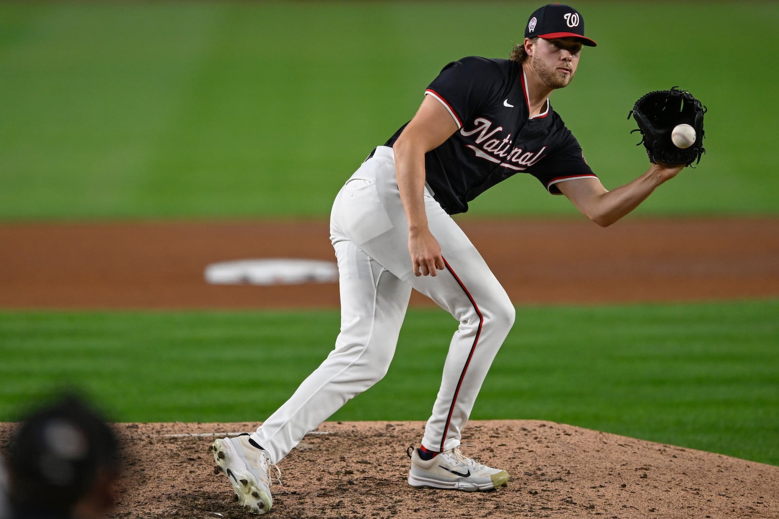 Washington Nationals starting pitcher Jake Irvin fields a louder by Atlanta Braves' Gio Urshela for the second out of the sixth inning of a baseball game, Wednesday, Sept. 11, 2024, in Washington. (AP Photo/John McDonnell)