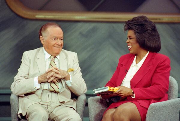 Comedian Bob Hope laughs with television talk show host Oprah Winfrey during a taping in Chicago. Hope reminisced before an audience that included war veterans that he entertained overseas. 