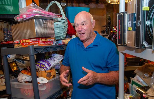 George Wieder talks about the thriller of find bargains that he collects for charities in the basement of his Tucker home. Photo by Phil Skinner for the AJC