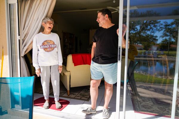 Longtime residents and neighbors, Fred Hodges, 71, and Mary Cumisky, 80, share a laugh while reminiscing about old parties at their community, at Cumiskys house at the Palms of Manasota, the first LGBTQ retirement community in the United States, Monday, Nov. 8, 2021, in Palmetto, Florida. (Martha Asencio-Rhine/Tampa Bay Times/TNS)