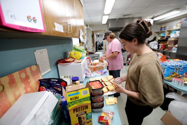 Samarra Mullis and Jack Lemburg make sandwiches for residents who sought shelter at St. Michael's and All Angels Episcopal Church as Hurricane Idalia impacted the area on Wednesday, August 30, 2023.