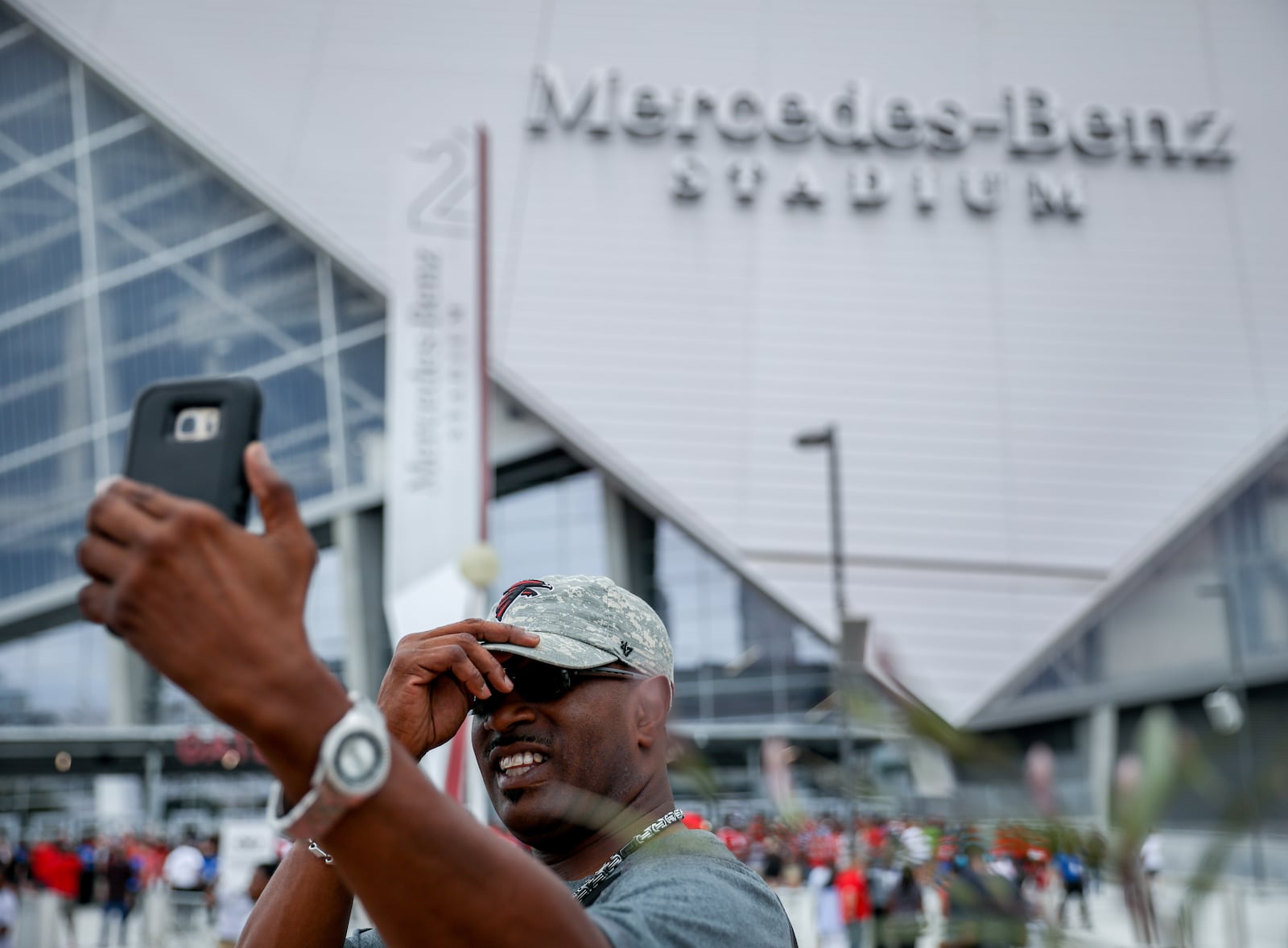 Troy Speights takes a selfie in front of Mercedes-Benz Stadium on Saturday.  