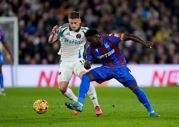 Newcastle United's Harvey Barnes, left, and Crystal Palace's Marc Guehi battle for the ball during the English Premier League soccer match between Crystal Palace and Newcastle United at Selhurst Park, London, Saturday Nov. 30, 2024. (Ben Whitley/PA via AP)