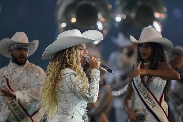 Beyoncé, center, performs alongside her daughter, Blue Ivy, right, during halftime of an NFL football game between the Baltimore Ravens and Houston Texans Wednesday, Dec. 25, 2024, in Houston. (AP Photo/David J. Phillip)