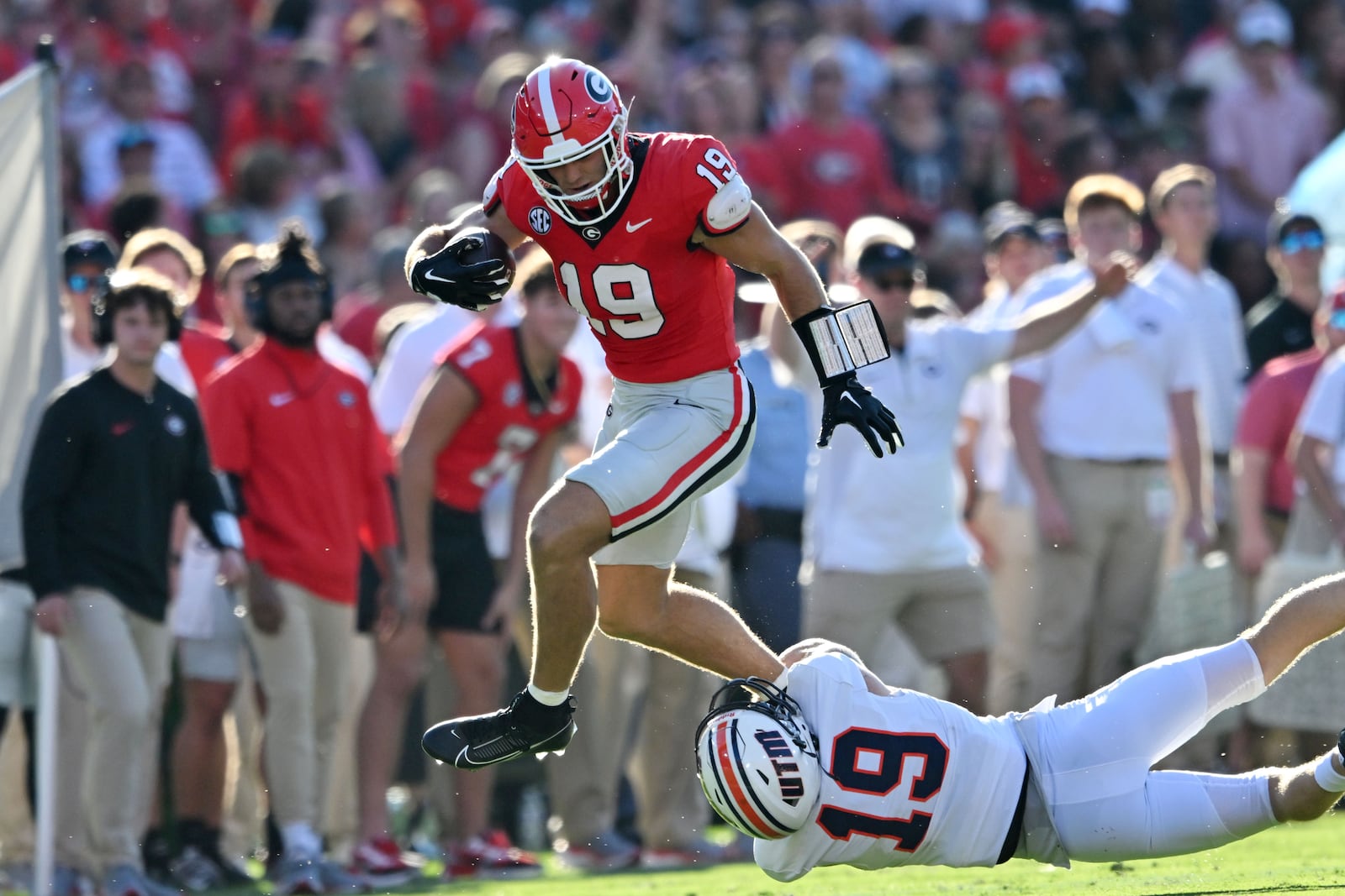 Georgia's tight end Brock Bowers (19) leaps over UT Martin's safety Jack Lucas (19) for yardage during the first half in an NCAA football game at Sanford Stadium, Saturday, September 2, 2023, in Athens. (Hyosub Shin / Hyosub.Shin@ajc.com)