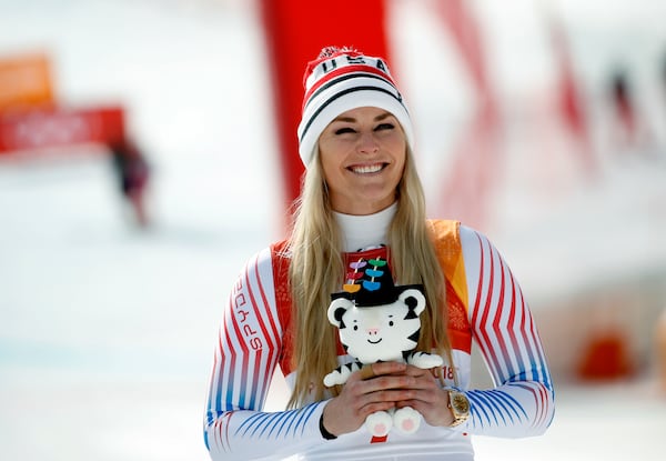 FILE - Bronze medal winner Lindsey Vonn, of the United States, smiles during the flower ceremony for the women's downhill at the 2018 Winter Olympics in Jeongseon, South Korea, Feb. 21, 2018. (AP Photo/Christophe Ena, File)