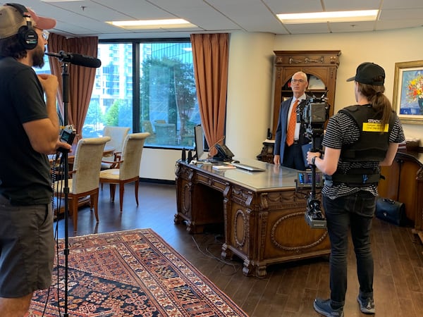 Lawyer John Foy gets ready to shoot a commercial. Foy's ads are on TV, radio, billboards and online. But longer on buses, as MARTA has moved to expel lawyers' ads from their "assets." (Courtesy)