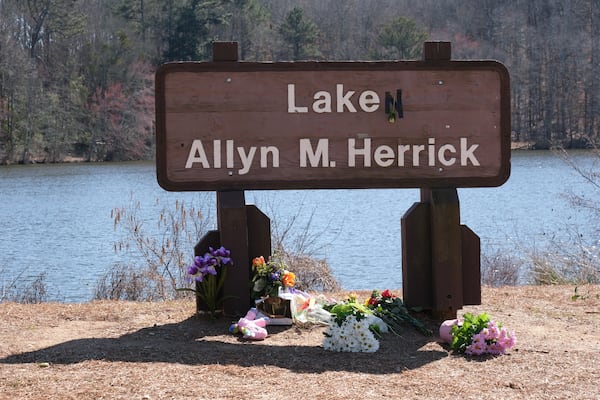 The sign for Lake Herrick has been altered to memorialize Laken Riley, who was killed Feb. 22, 2024 on the running trails behind the lake last week in Athens, Georgia. This photo was taken Feb. 26.  (Nell Carroll for The Atlanta Journal-Constitution)