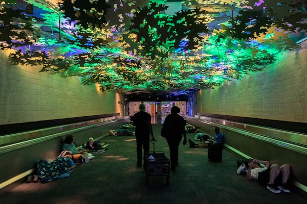 Passengers slept overnight in the underground walkways at Hartsfield-Jackson International Airport after flight cancellations continued on Saturday, July 20, 2024. Credit: Arvin Temkar / arvin.temkar@ajc.com