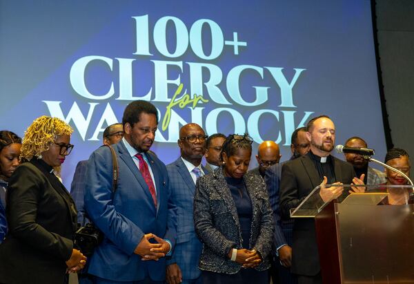 Multiple faith leaders from in and around Georgia gather at the Center for Civil and Human Rights to rally support for U.S. Sen. Raphael Warnock on Nov 28, 2022. (Jenni Girtman for The Atlanta Journal-Constitution)