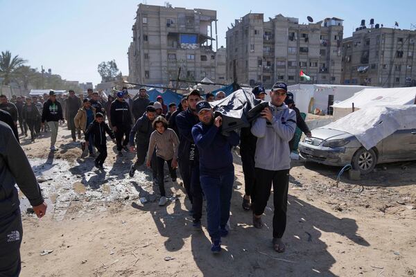 Palestinians carry the body of Ismail Barhoum, a member of Hamas' political bureau who was killed is an Israeli army strike of Nasser Hospital in Khan Younis, Gaza Strip, Monday, March 24, 2025. (AP Photo/Abdel Kareem Hana)