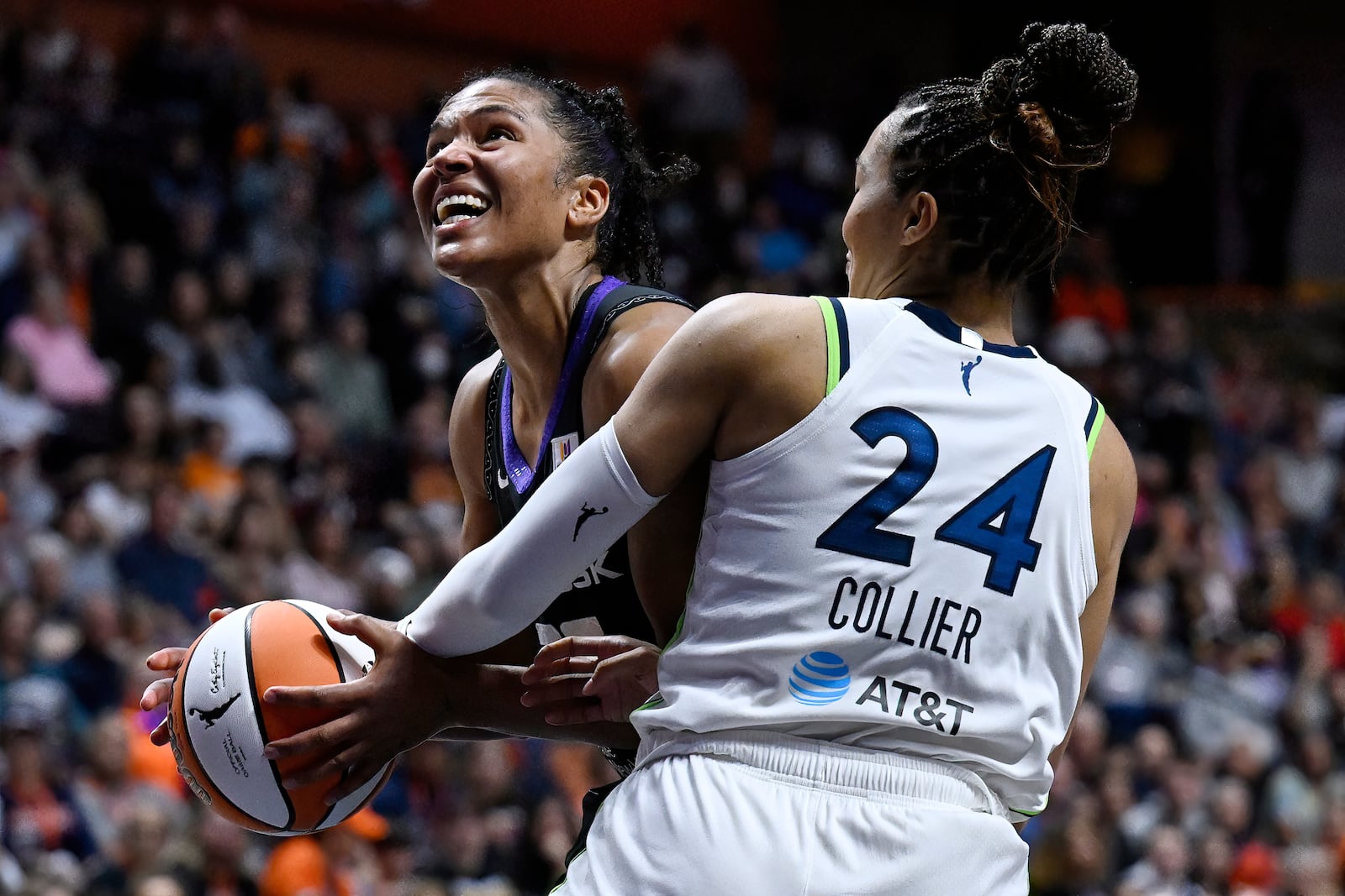 Minnesota Lynx forward Napheesa Collier (24) fouls Connecticut Sun forward Alyssa Thomas during the second half of Game 4 in the WNBA basketball semifinals, Sunday, Oct. 6, 2024, in Uncasville, Conn. (AP Photo/Jessica Hill)