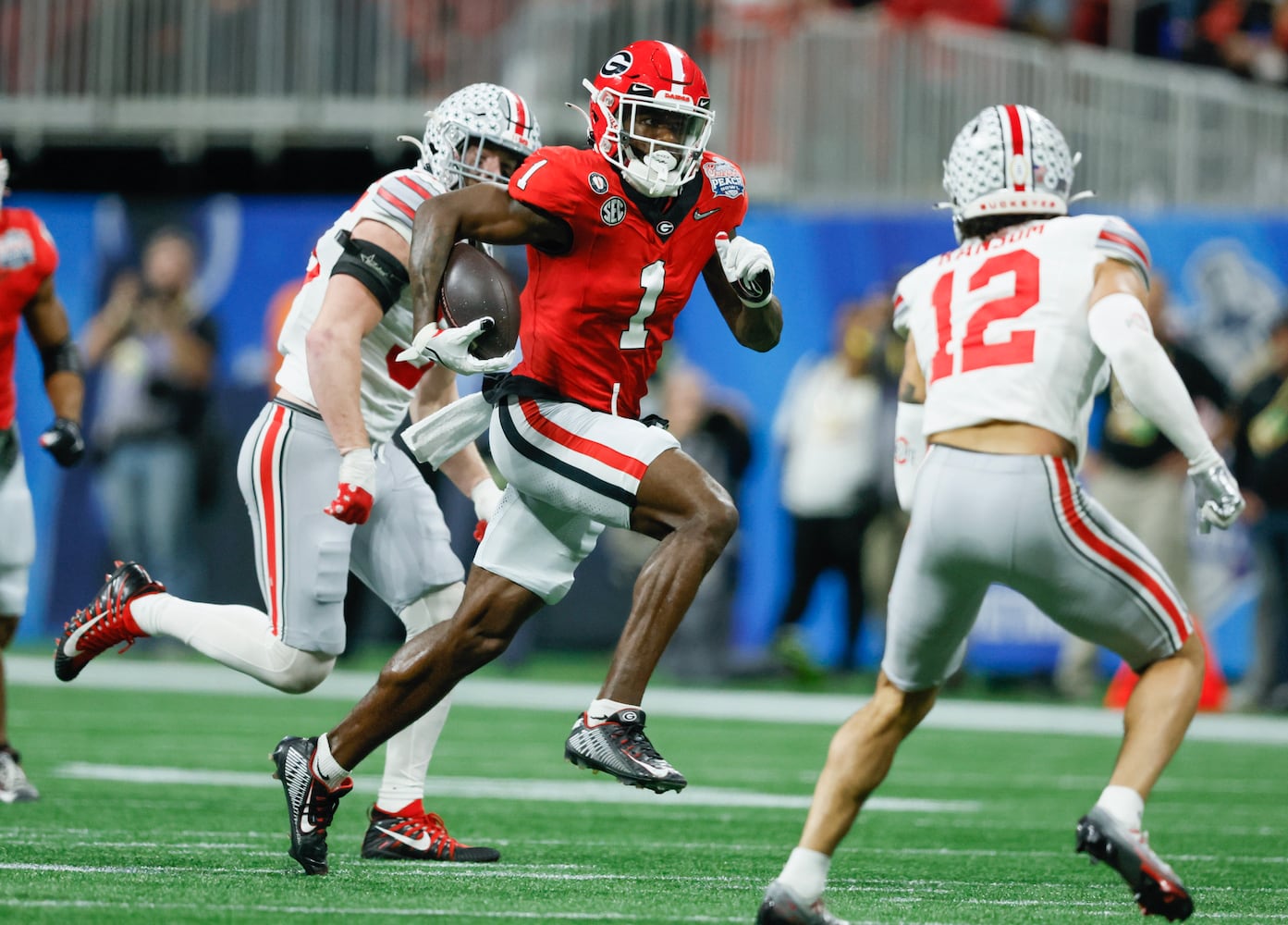 Georgia Bulldogs wide receiver Marcus Rosemy-Jacksaint (1) gains first down yardage on a 28 yard third down play during the second quarter of the College Football Playoff Semifinal between the Georgia Bulldogs and the Ohio State Buckeyes at the Chick-fil-A Peach Bowl In Atlanta on Saturday, Dec. 31, 2022. (Jason Getz / Jason.Getz@ajc.com)