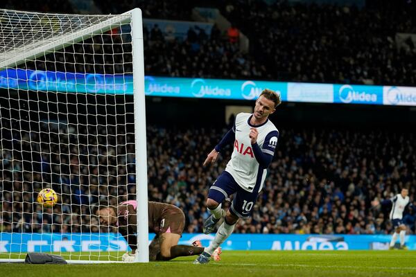 Tottenham's James Maddison scores the opening goal during the English Premier League soccer match between Manchester City and Tottenham at the Etihad Stadium in Manchester, England, Sunday, Nov. 24, 2024. (AP Photo/Dave Thompson)