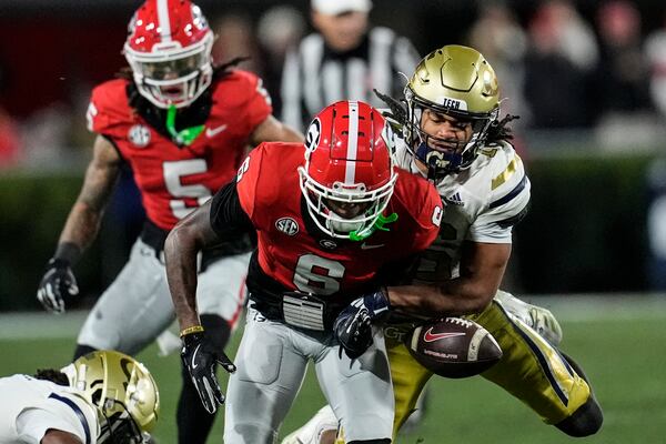 Georgia Tech defensive back Syeed Gibbs (16) strips the ball from Georgia wide receiver Dominic Lovett (6) causing a fumble during the first half of an NCAA college football game, Friday, Nov. 29, 2024, in Athens, Ga. (AP Photo/Mike Stewart)