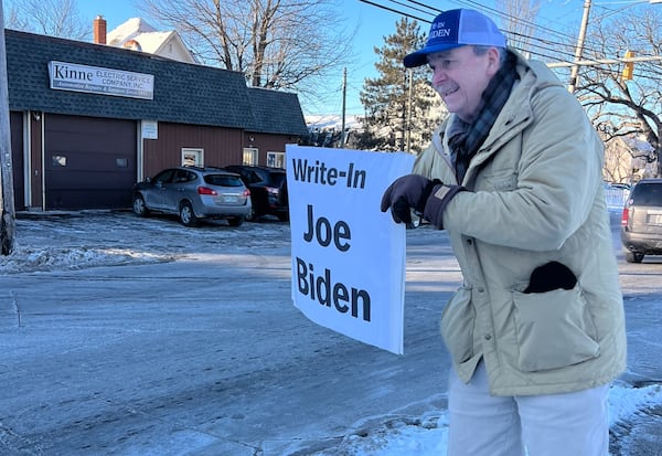 Bob Mulholland waving a “write-in Joe Biden” sign on Hooksett Road in Manchester, New Hampshire. (Patricia Murphy/patricia.murphy@ajc.com)