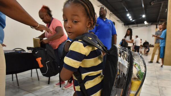 Jacques Thomas, 4, turns his head to check his school supplies inside a clear backpack during No Bare Soles Annual Shoe Distribution at Caring For Others headquarters on Saturday, July 15, 2017.