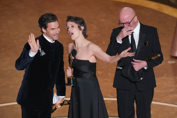 Clement Ducol, from left, Camille, and Jacques Audiard accept the award for best original song for "El Mal" from" Emilia Perez" during the Oscars on Sunday, March 2, 2025, at the Dolby Theatre in Los Angeles. (AP Photo/Chris Pizzello)