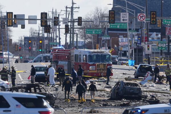 Investigators work the scene where a small plane crashed in Philadelphia, Saturday, Feb. 1, 2025. (AP Photo/Matt Rourke)