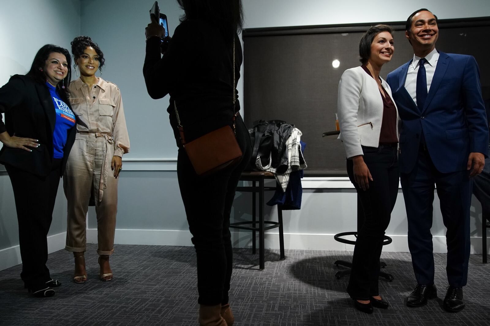 U.S. Democratic presidential candidate Julián Castro, right, and CNN political commentator Angely Rye, left, take photos with attendees following a conversation at Paschal's on November 19, 2019, in Atlanta. Elijah Nouvelage for The Atlanta Journal-Constitution