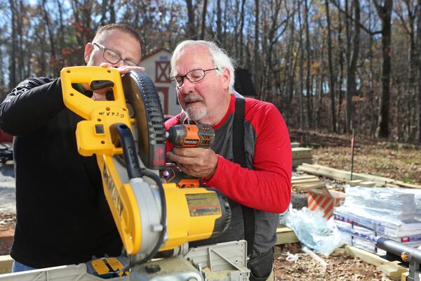 Veterans Roger Mckelson (right) and Josh Lear (left) volunteer with the Cherokee County Homeless Veteran Program to build a handicap ramp at the future home of a disabled veteran on Friday, November 20, 2020, in Canton, Georgia. The program is run by Army veteran John Lindenmayer, and is a part of a nationwide patchwork of volunteer veterans helping other veterans in need. CHRISTINA MATACOTTA FOR THE ATLANTA JOURNAL-CONSTITUTION