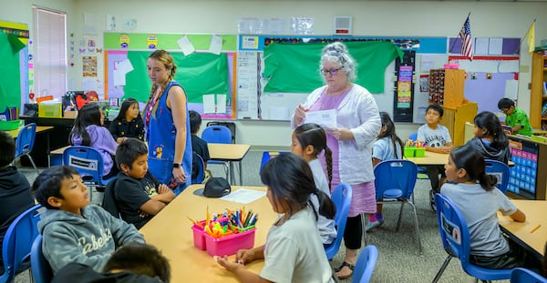 Third grade teachers Ciara Key, left, and Arden Serrato handing out tests, Tuesday, Oct. 1, 2024, at Algodones Elementary School in Algodones, N.M. (AP Photo/Roberto E. Rosales)