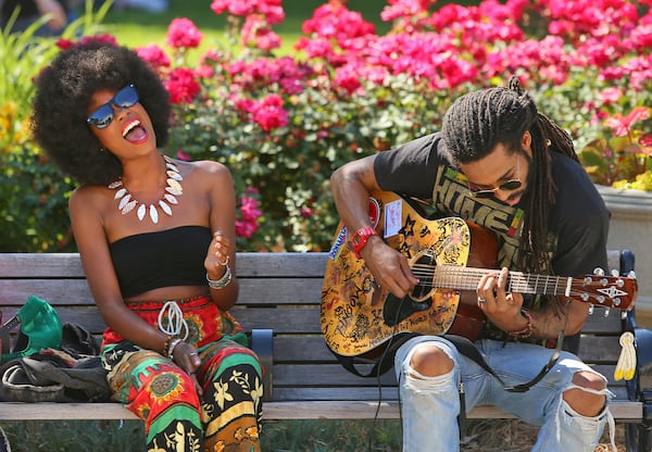 The performers CHE'ZEE attracted their share of fans performing on a park bench in Piedmont Park during the 36th annual Atlanta Jazz Festival on Sunday, May 26, 2013, in Atlanta.   (AJC 2013)