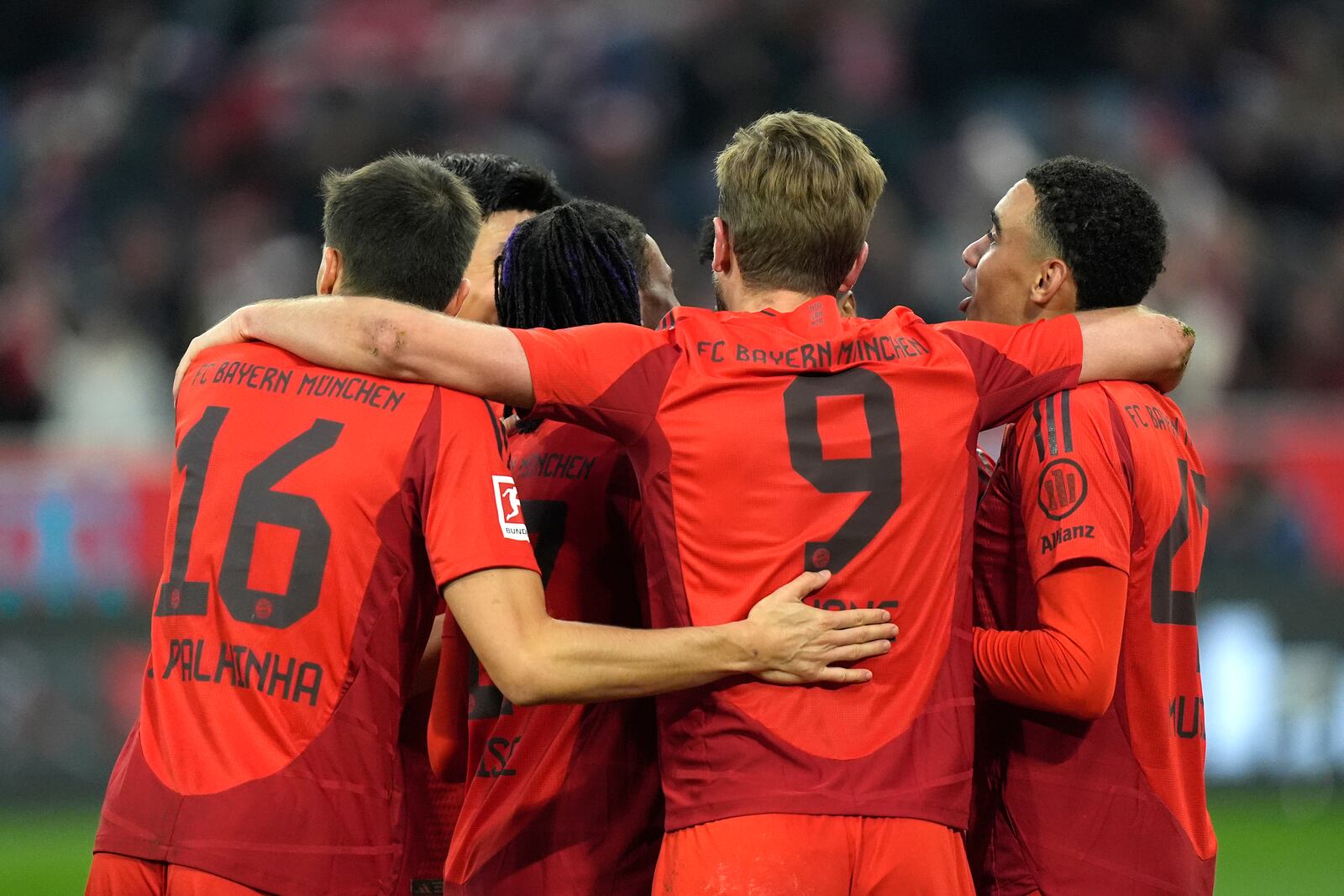 Bayern Munich players celebrate after Bayern's Harry Kane, centre, scored his side's third goal during the Bundesliga soccer match between Bayern Munich and Union Berlin at the Allianz Arena in Munich, Germany, Saturday, Nov. 2, 2024. (AP Photo/Matthias Schrader)