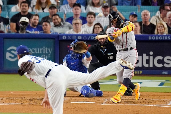 Atlanta Braves' Ronald Acuna Jr., right, hits a grand slam as Los Angeles Dodgers starting pitcher Lance Lynn, left, watches along with catcher Will Smith, second from left, and home plate umpire Dan Bellino during the second inning of a baseball game Thursday, Aug. 31, 2023, in Los Angeles. (AP Photo/Mark J. Terrill)