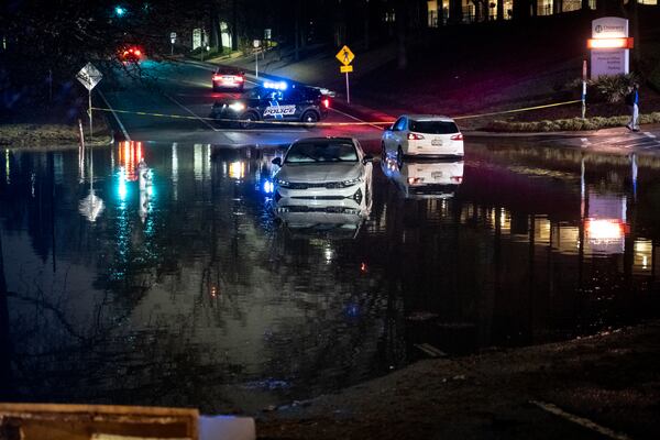 Water floods Meridian Mark Road next to Children's Heathcare of Atlanta on Thursday. Two cars were abandoned in the water. (Ben Hendren for The Atlanta Journal-Constitution)