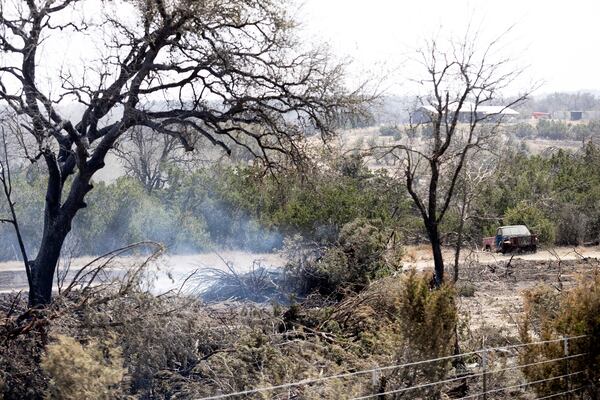 A hotspot in the Crabapple Fire smokes North State Highway 16 near Fredericksburg, Texas, Monday, March 17, 2025. (Josie Norris/The San Antonio Express-News via AP)