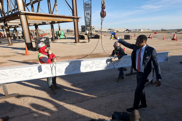 Atlanta Mayor Andre Dickens sounds a horn as a beam is put into place during an event as construction is underway to widen Hartsfield-Jackson Concourse D at the Modular Yard near the Hartsfield-Jackson International Airport, Thursday, December. 14, 2023, in Atlanta. During the $1.3 billion project, starting next April each modular component will be transported and connected onto Concourse D, enabling most gates to remain active throughout. (Jason Getz / Jason.Getz@ajc.com)