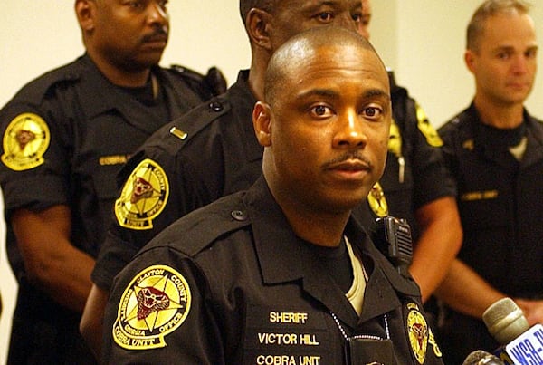 Former Sheriff Victor Hill distributed the badges and ID cards to campaign workers, pastors and some of his friends