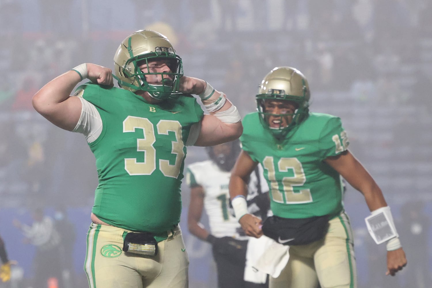 Buford fullback Nate Norys (33) celebrates after quarterback Ashton Daniels, right, scored a rushing touchdown during the third quarter against Langston Hughes in the Class 6A state title football game at Georgia State Center Parc Stadium Friday, December 10, 2021, Atlanta. JASON GETZ FOR THE ATLANTA JOURNAL-CONSTITUTION