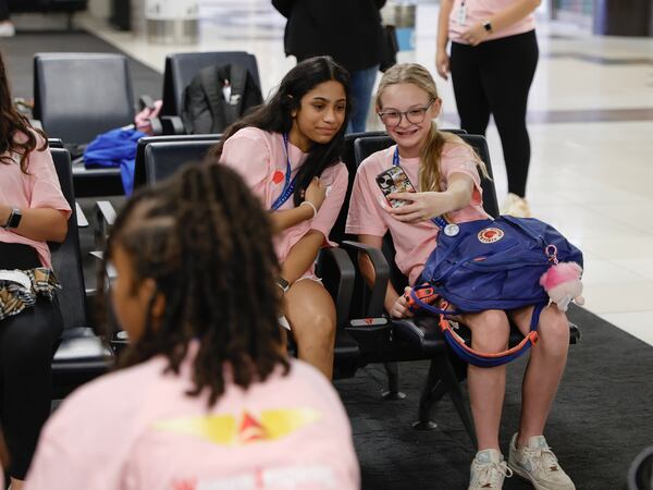 Ava Patel, 13, and Ryan Haselden, 12, participants of Women Inspiring our Next Generation’ (WING) program, take a selfie while waiting for their flight at Hartsfield-Jackson International Airport on Friday, Sept. 22, 2023. Delta’s WING program is an all-female charter flight that carries 100 young women interested in aviation from Atlanta to NASA’s Kennedy Space Center in Florida. (Natrice Miller/ Natrice.miller@ajc.com)