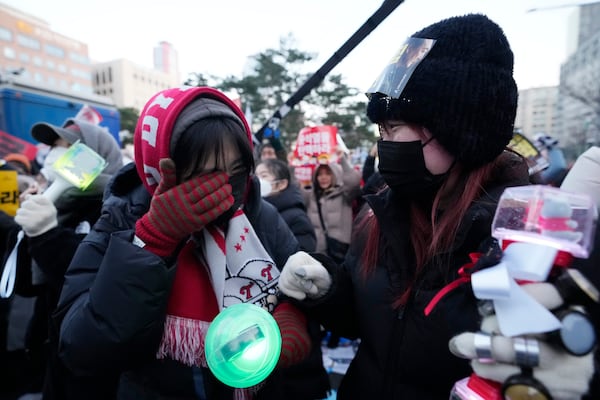 A participant weeps after hearing the news that South Korea's parliament voted to impeach President Yoon Suk Yeol outside the National Assembly in Seoul, South Korea, Saturday, Dec. 14, 2024. (AP Photo/Lee Jin-man)