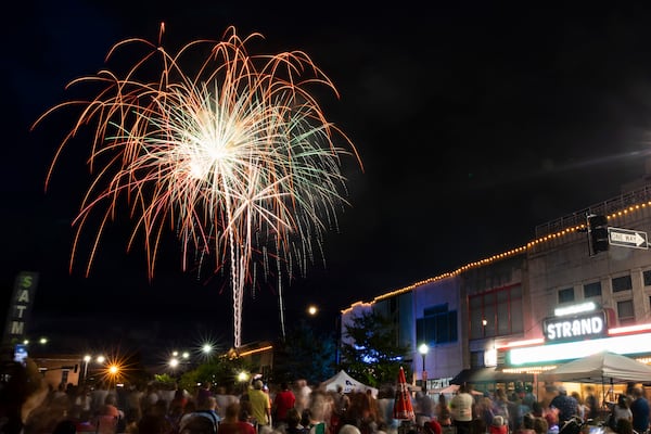 Spectators watch fireworks next to Glover Park in Marietta, Georgia, on Monday, July 4, 2022, as part of the city’s 4th In the Park Celebration. The show had only been going for a few minutes when the crowd was sent scrambling for cover from heavy rain. (Chris Day/Christopher.Day@ajc.com)