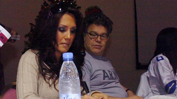 In this image provided by the U.S. Army, sportscaster Leeann Tweeden and then-comedian Al Franken meet and greet military members during an autograph signing session of the USO Sergeant Major of the Army's 2006 Hope and Freedom Tour in Camp Arifjan, Kuwait, on Dec. 14, 2006. Sen. Al Franken, D-Minn., apologized Nov. 16, 2017, after Tweeden accused him of forcibly kissing her during the 2006 USO tour. Colleagues, including fellow Democrats, urged a Senate ethics investigation. Tweeden also accused Franken of posing for a photo with his hands on her breasts as she slept, while both were performing for military personnel two years before Franken was elected to the Senate. (Sgt. Thomas Day/U.S. Army 40th via AP)