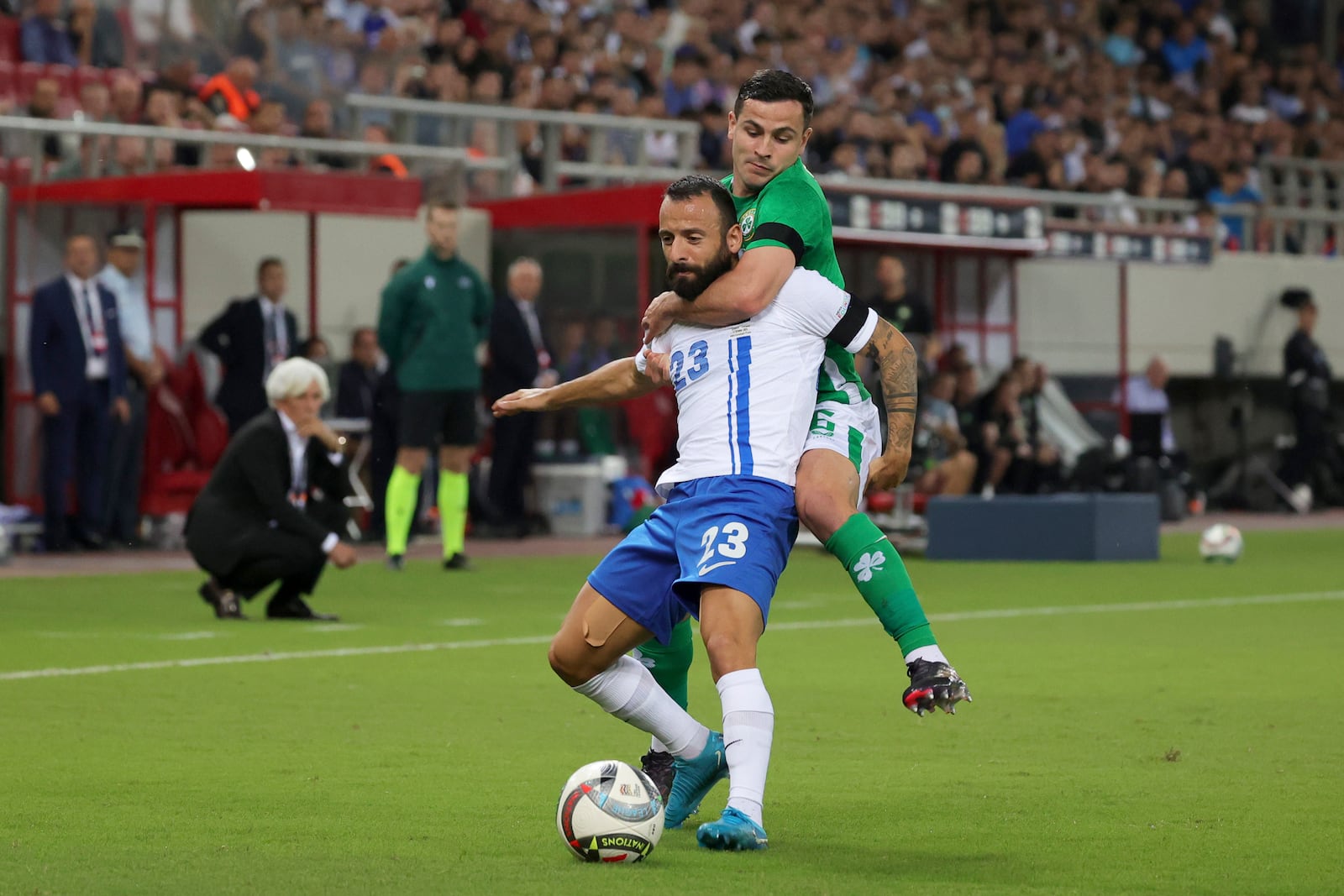 Ireland's Josh Cullen fights for the ball with Greece's Manolis Siopis, left, during a Nations League soccer match between Greece and Ireland at the Georgios Karaiskakis Stadium in Piraeus port, near Athens, Sunday, Oct. 13, 2024. (AP Photo/Yorgos Karahalis)